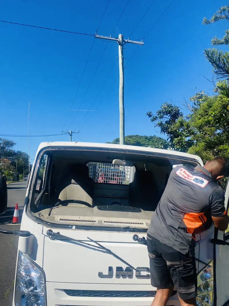 Budget Auto Glass technician fitting a windscreen at the kerb
